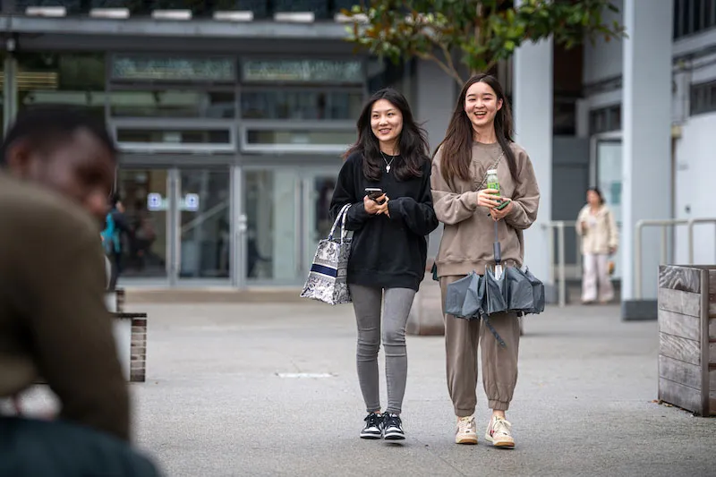 Image shows two UCA students walking outside campus