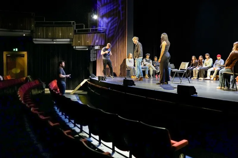 Acting students taking direction from the stage at Bloomsbury Theatre