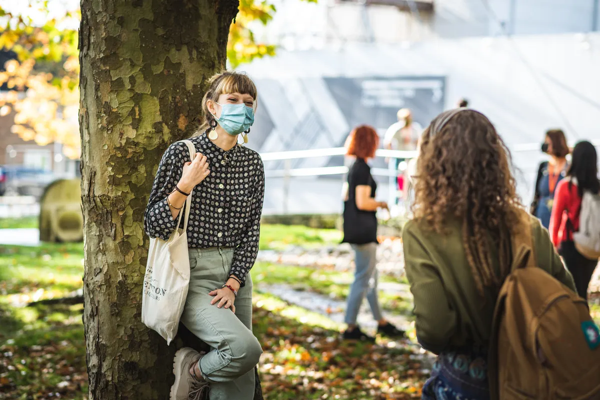 Students stood outside the film and media centre at UCA Farnham wearing face coverings