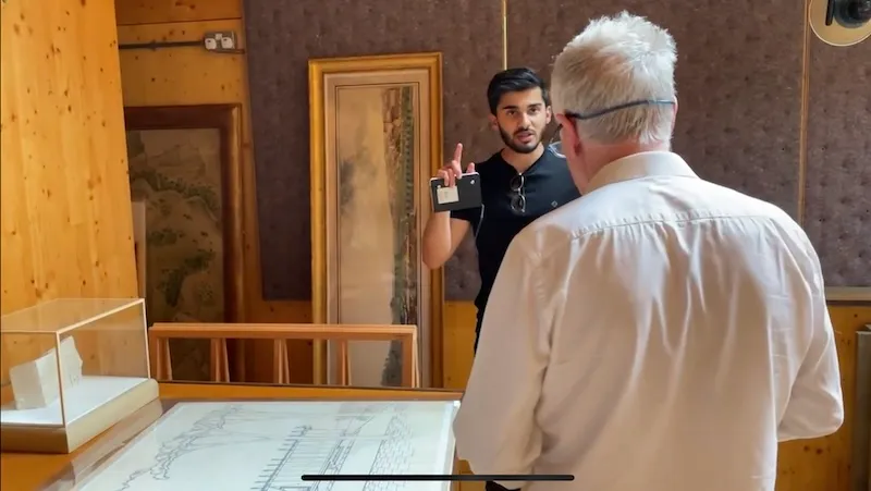 Hamza Shaikh talking to a colleague who is not facing the camera