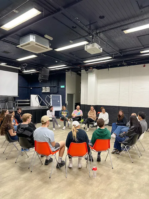Students sit in a circle with Abigail Sol, from Talawa, to discuss sensitive issues in a safe space