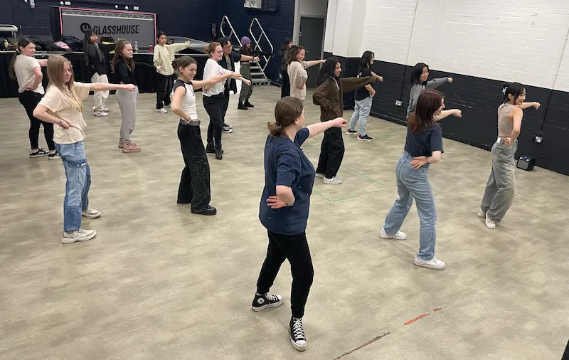 K-Pop dance club presidents Eugenie Biron, Yuting Zhuang and Caitlin Visser at the front teaching the club a new dance