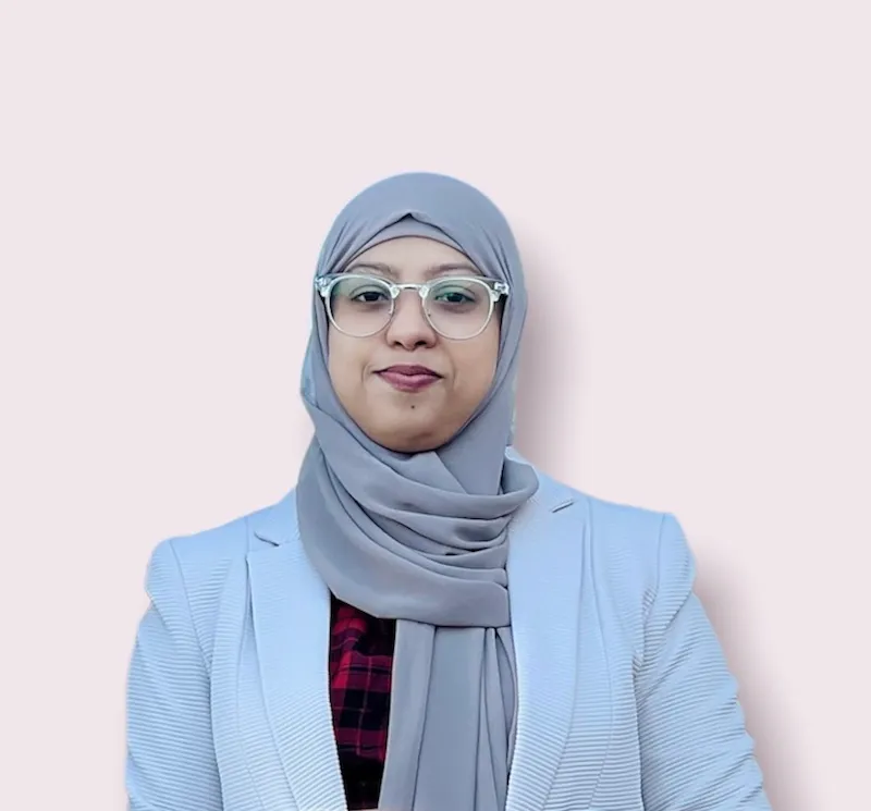 A head and shoulders image of international student Umme Salma. She is wearing a pastel blue jacket and grey headscarf