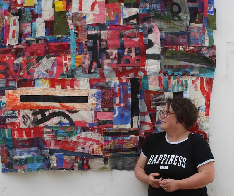 Picture of UCA mature student Vicki Salmi in front of her abstract art
