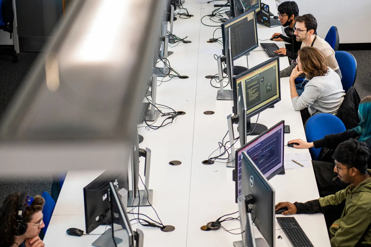 Overhead shot of students working at computers in a Games Studio