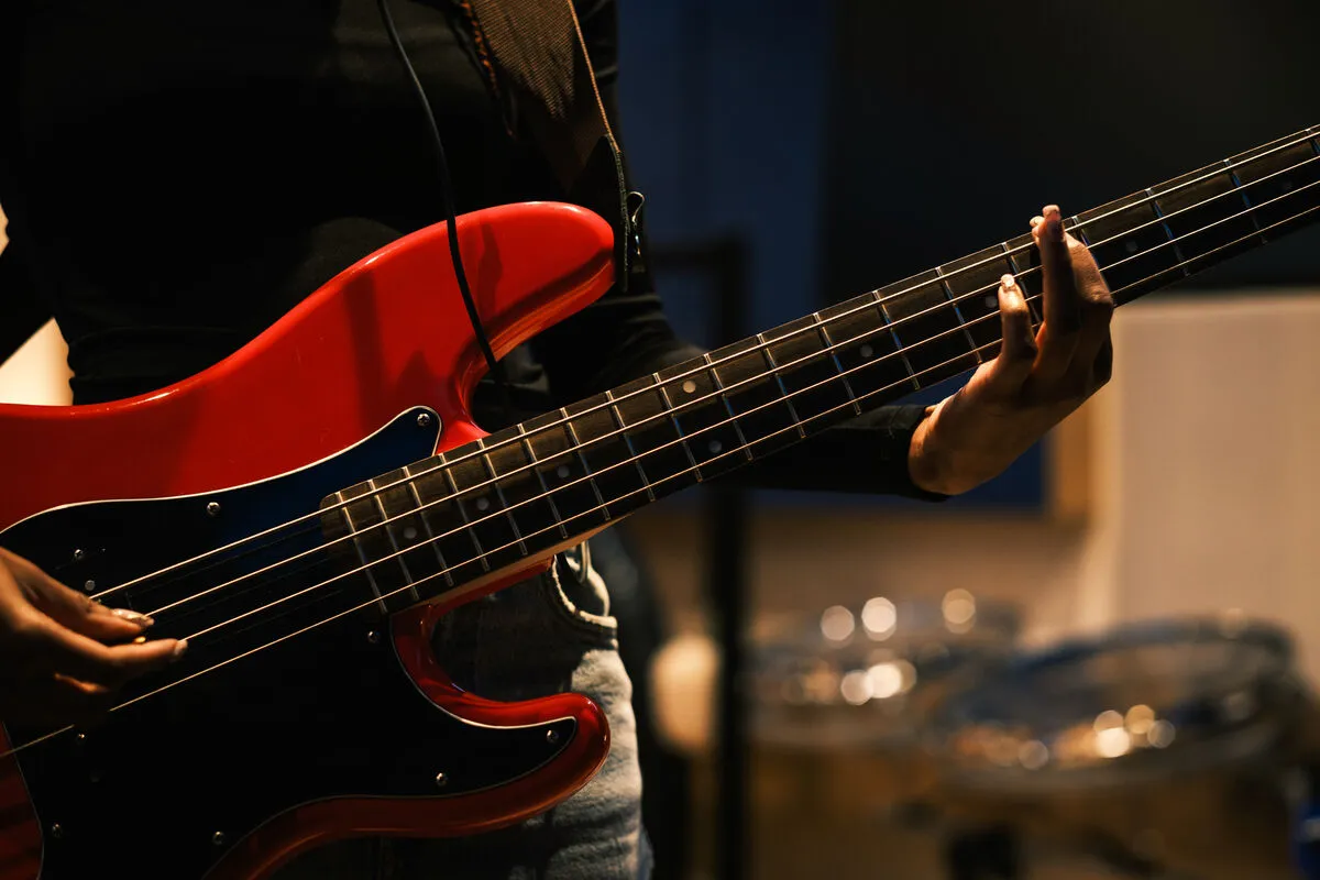 Student playing guitar in a UCA music studio
