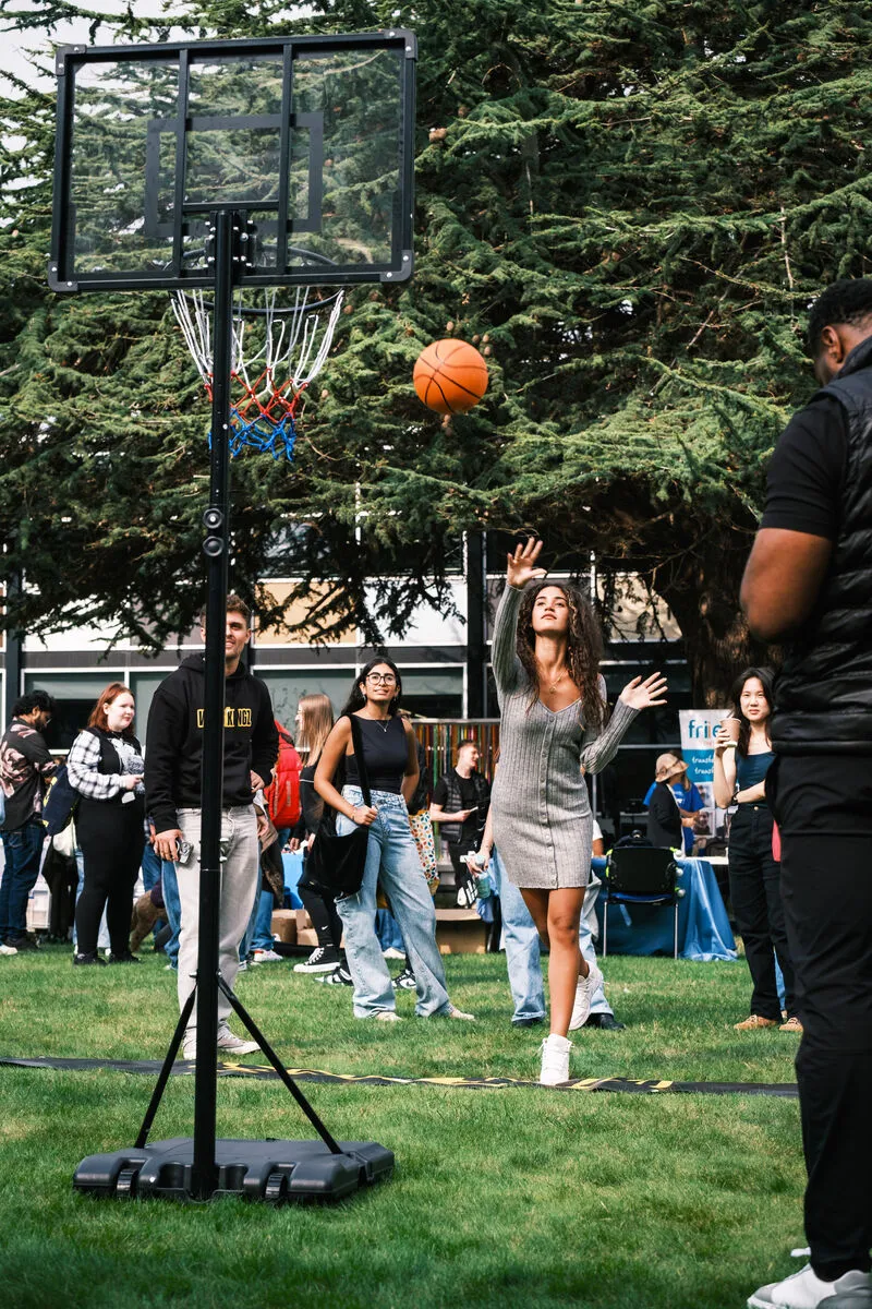 A student playing basketball at the Freshers' Fair