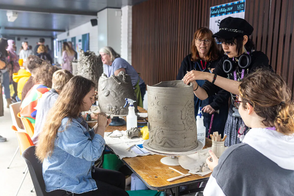 Students shaping clay at the Freshers' Fair