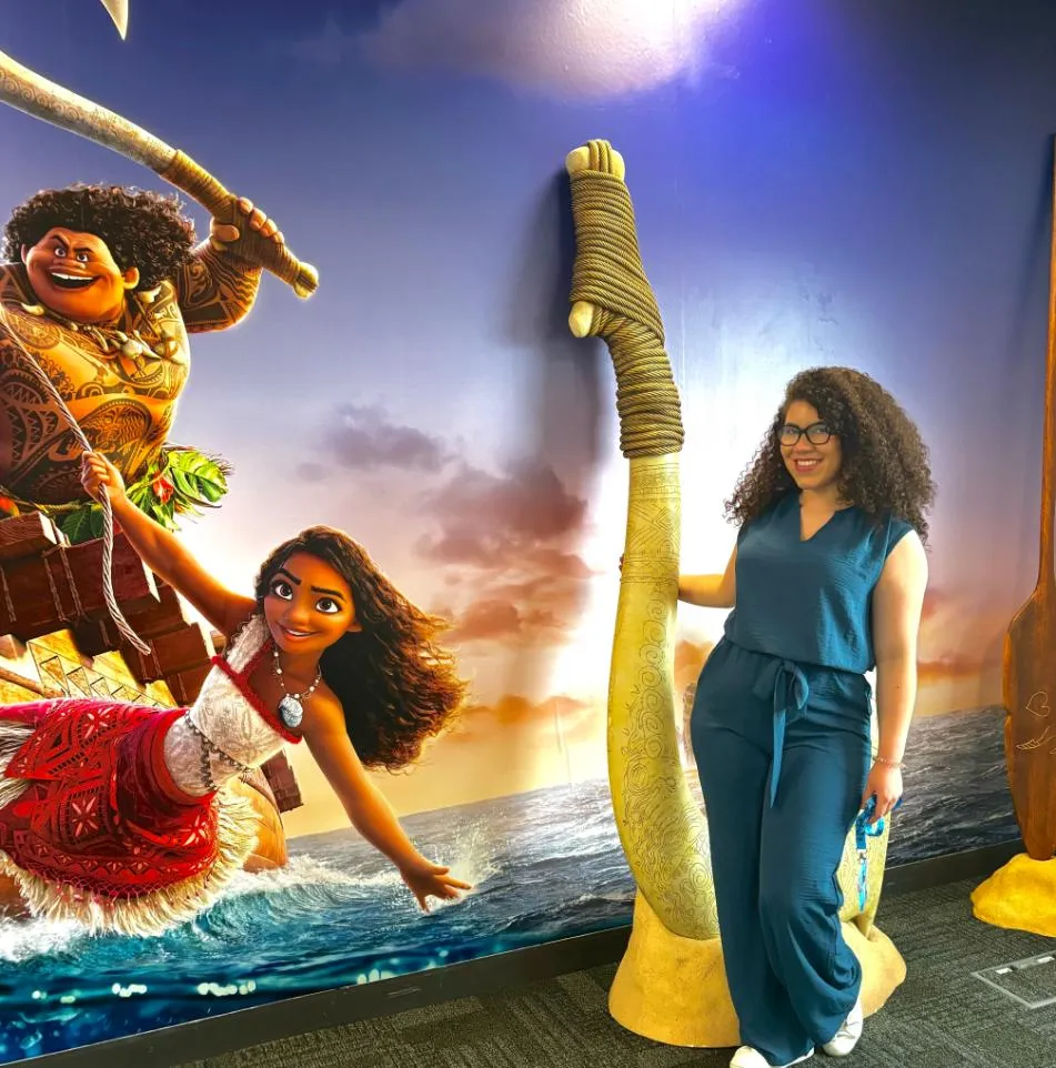 UCA student, Nicole Clachar, posing in front of a Moana poster