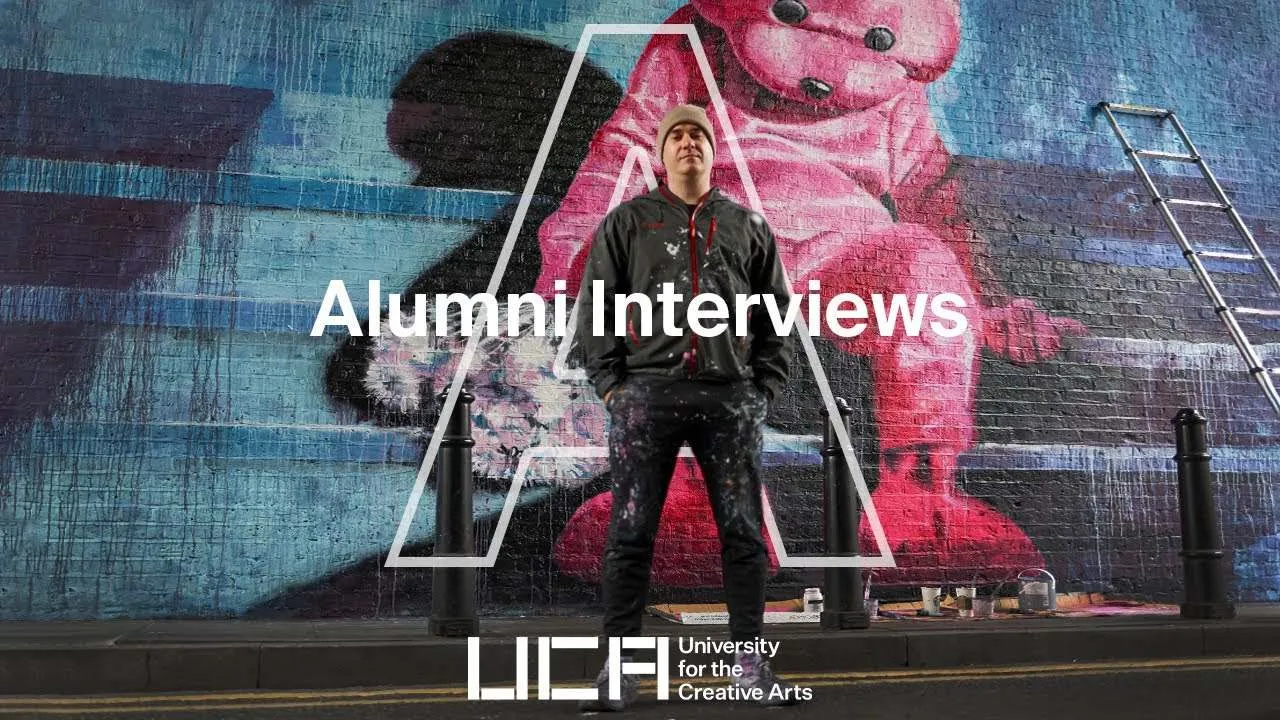 Paul Robinson posing in front of one of his large wall mural paintings