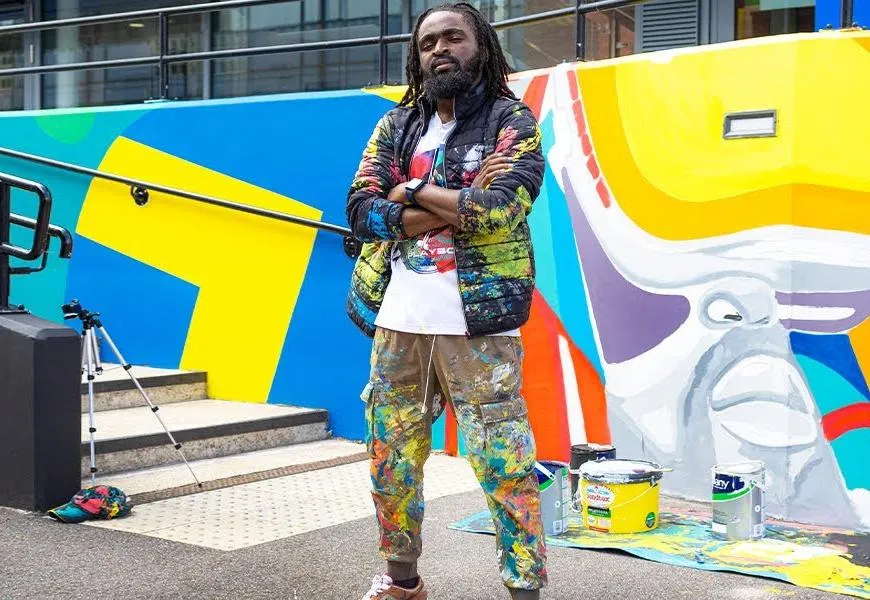 Oluwafemi Babalola MA Fine Art student, showcasing his final major project to life on one of the walls at our Farnham campus