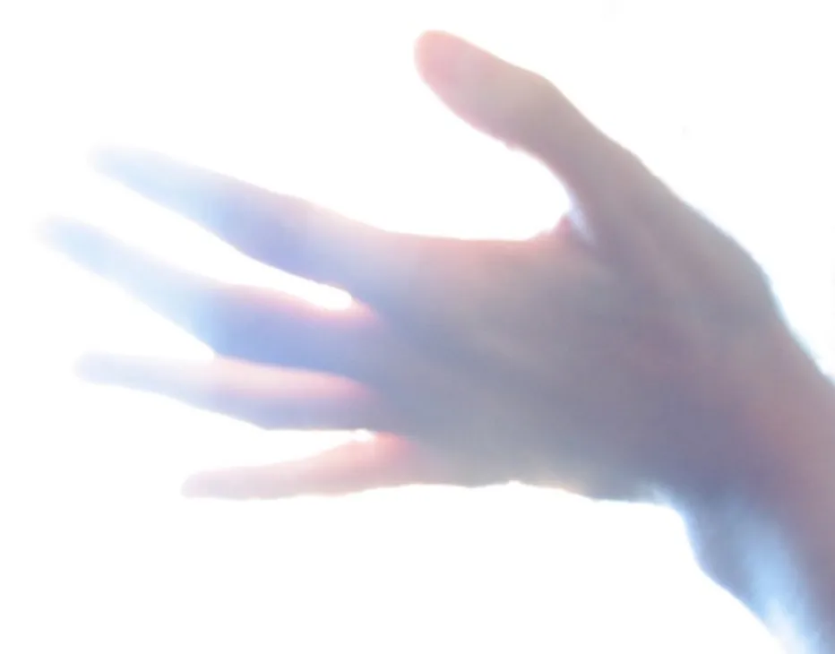 extended hand in bright light