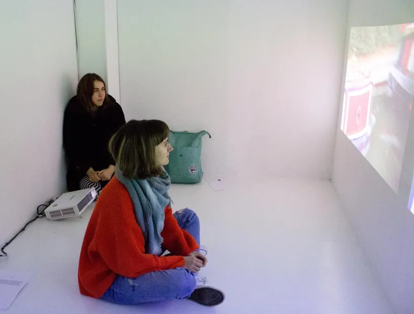 Visitors watching the Standing Still exhibition