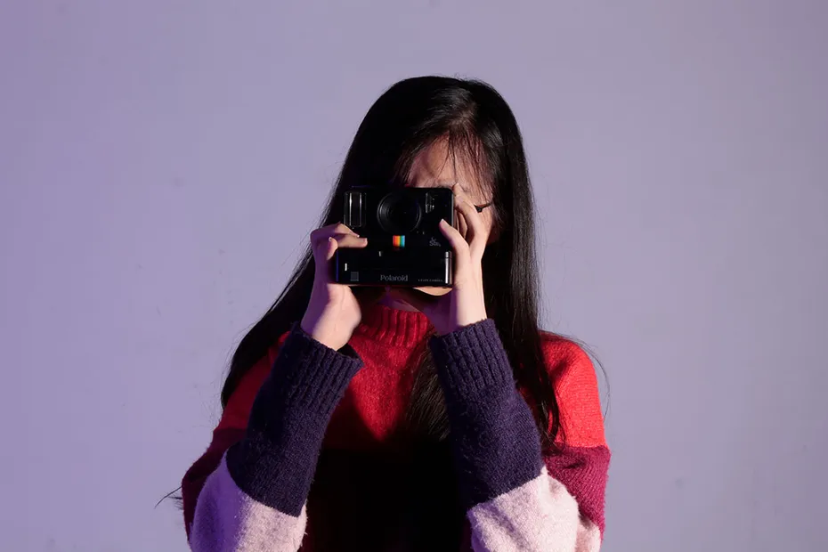 Student holding camera