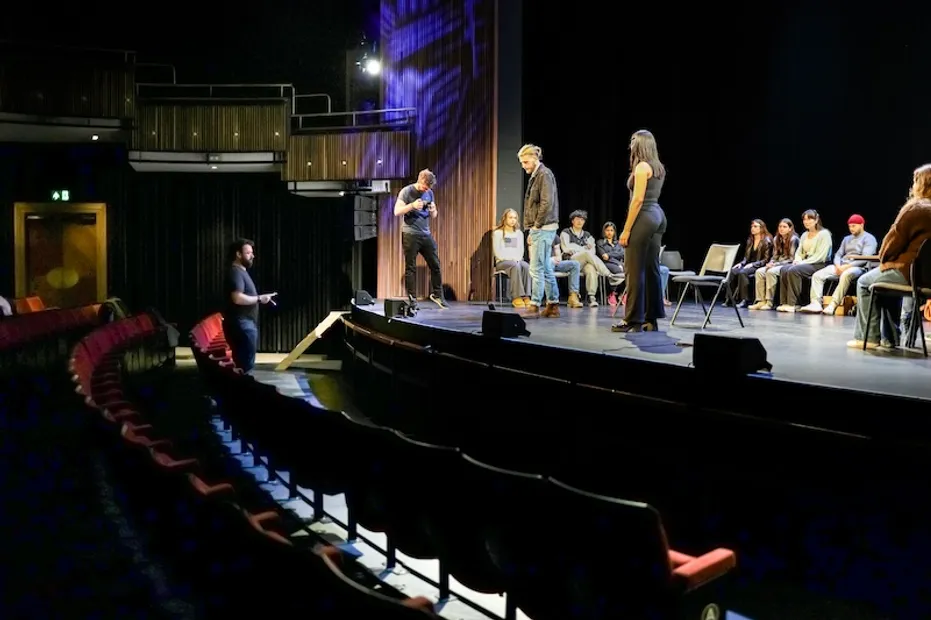 Acting students taking direction from the stage at Bloomsbury Theatre