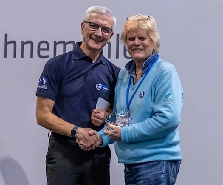 Marilyn Taylor, right, receiving her prize from a representative of the London Camera Exchange