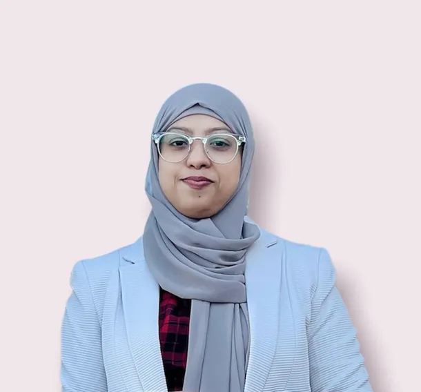 A head and shoulders image of international student Umme Salma. She is wearing a pastel blue jacket and grey headscarf