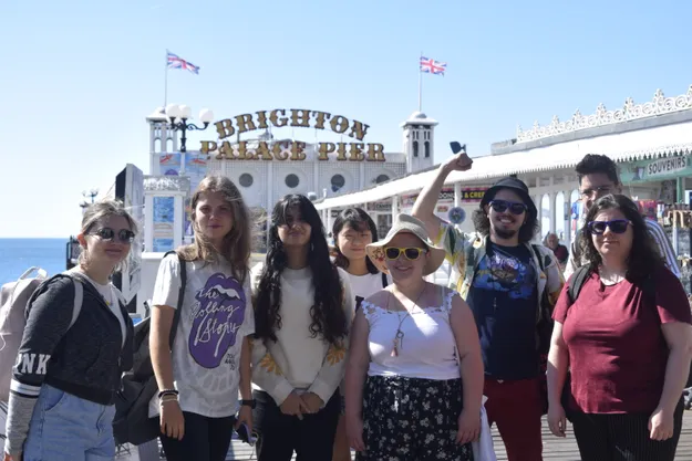 Students standing in front of Brighton pier