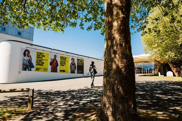 Student walking to the entrance of UCA Farnham