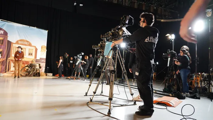 Student filming a production on a Maidstone TV Studio set