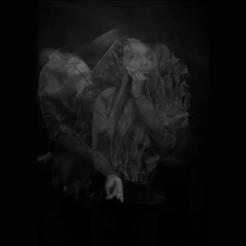 A distorted long exposure photograph of a girl against a black background