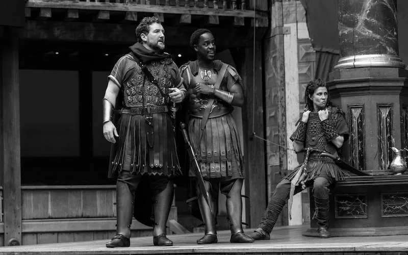 UCA acting and performance alumni Gabin Kongolo, right, on stage at Shakespeare's Globe