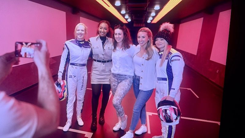 Georgina Sadler in a behind the scenes shot with four other women in motorsport