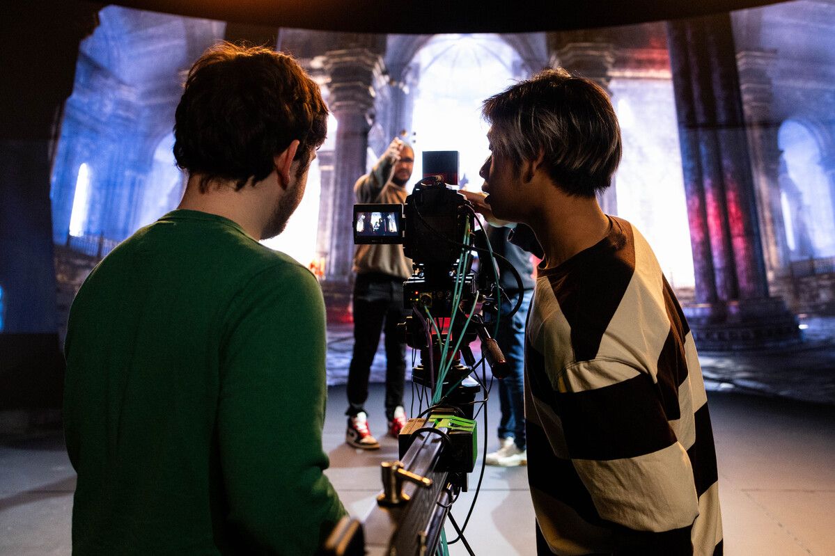 Two people operating a camera in the virtual production studio