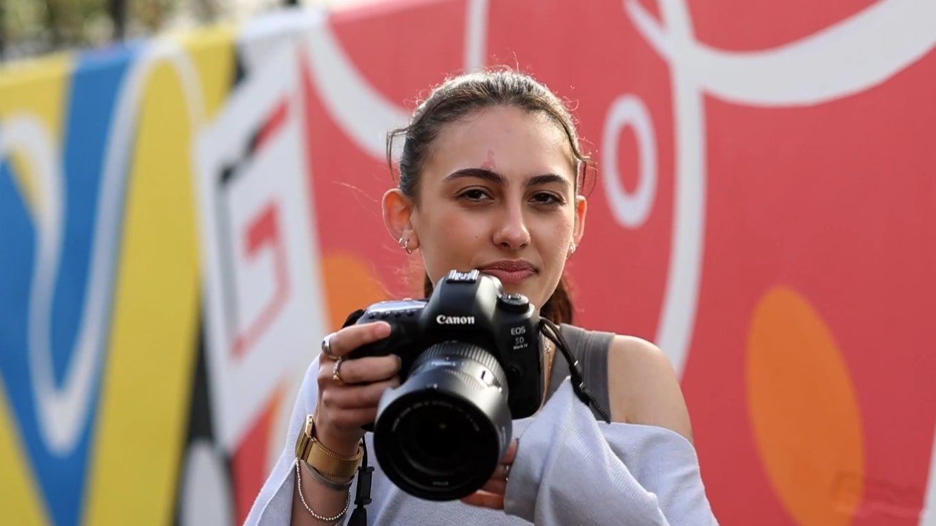 A photography student preparing to take a photo
